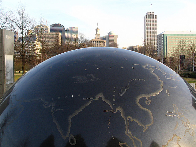 A sculpture of a globe with the Nashville capitol building visible in the background.