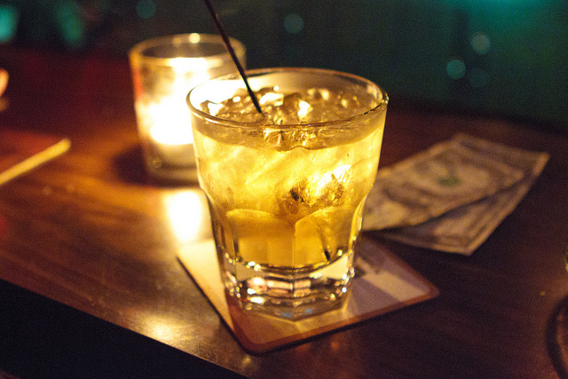 Whiskey on the rocks at a bar.