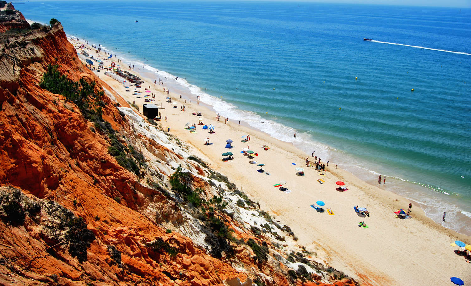 Praia da Falésia's coloured cliffscape make for picturesque strolling. Image by Eloy Rodriguez / Moment Open / Getty