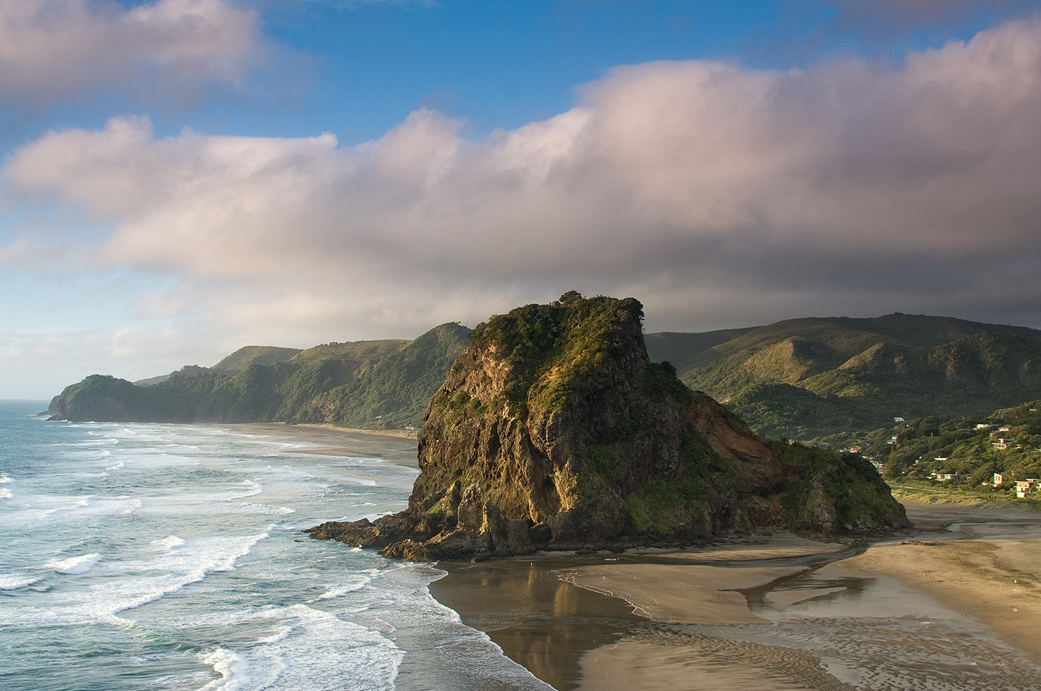 Frothing waves and craggy headlands, like Lion Rock, conspire to make Piha Beach one of New Zealand's most rugged shores. Image by russellstreet / CC BY-SA 2.0