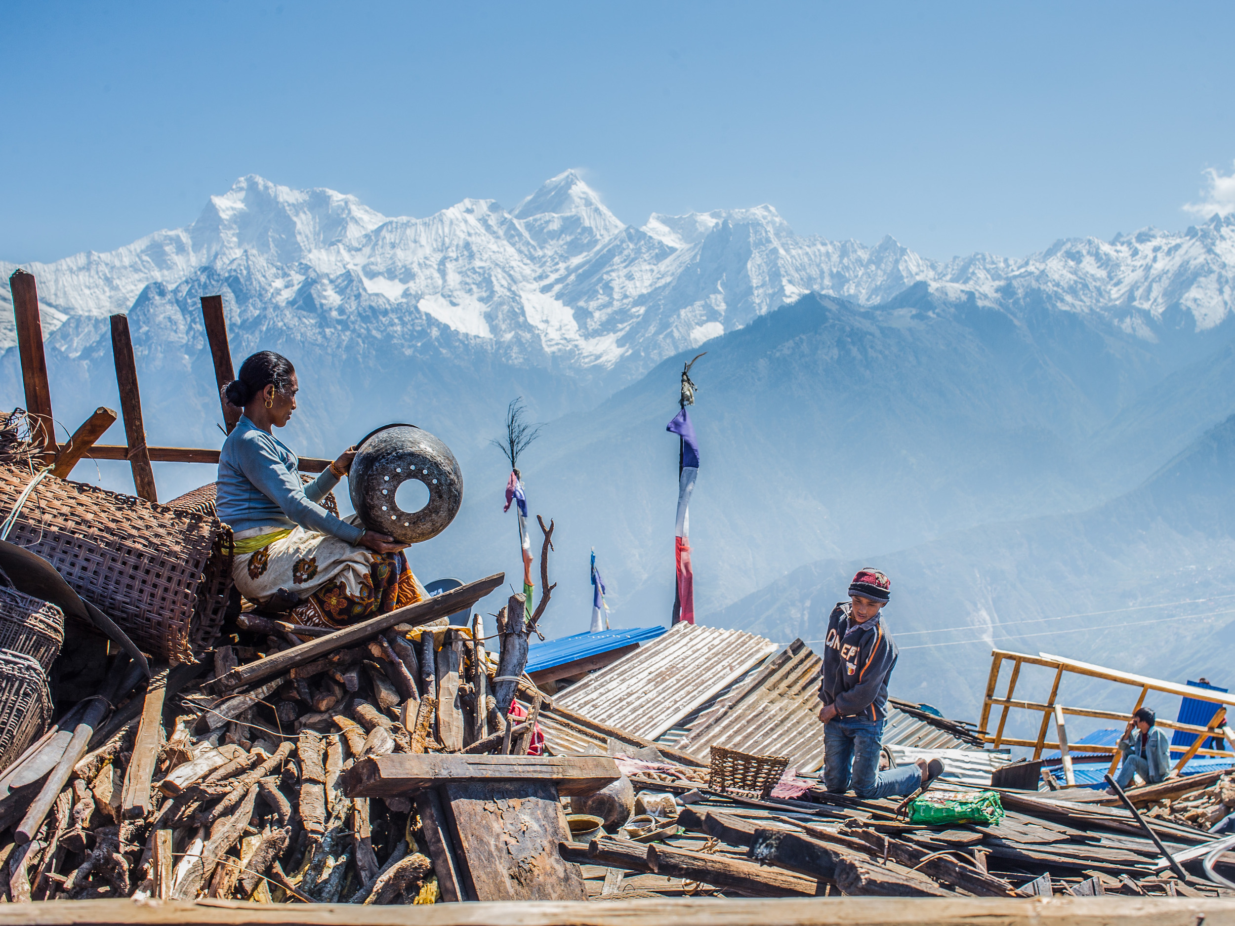 A woman from Singla village extracts her belongings from the rubble. Image by Asian Development Bank / CC by 2.0