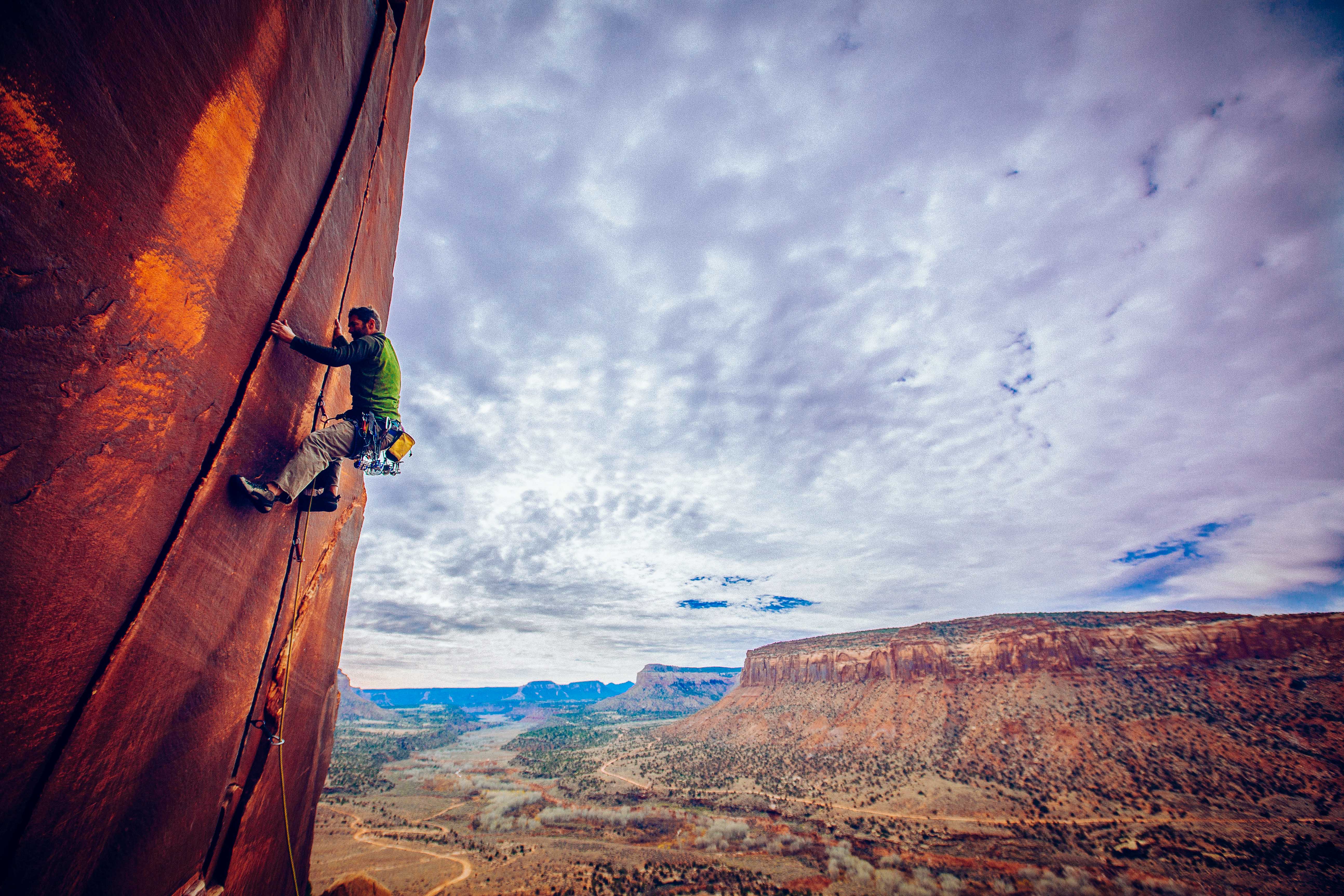 A climber scales a crack at Indian Creek. Image by  Mike Schirf / Aurora / Getty