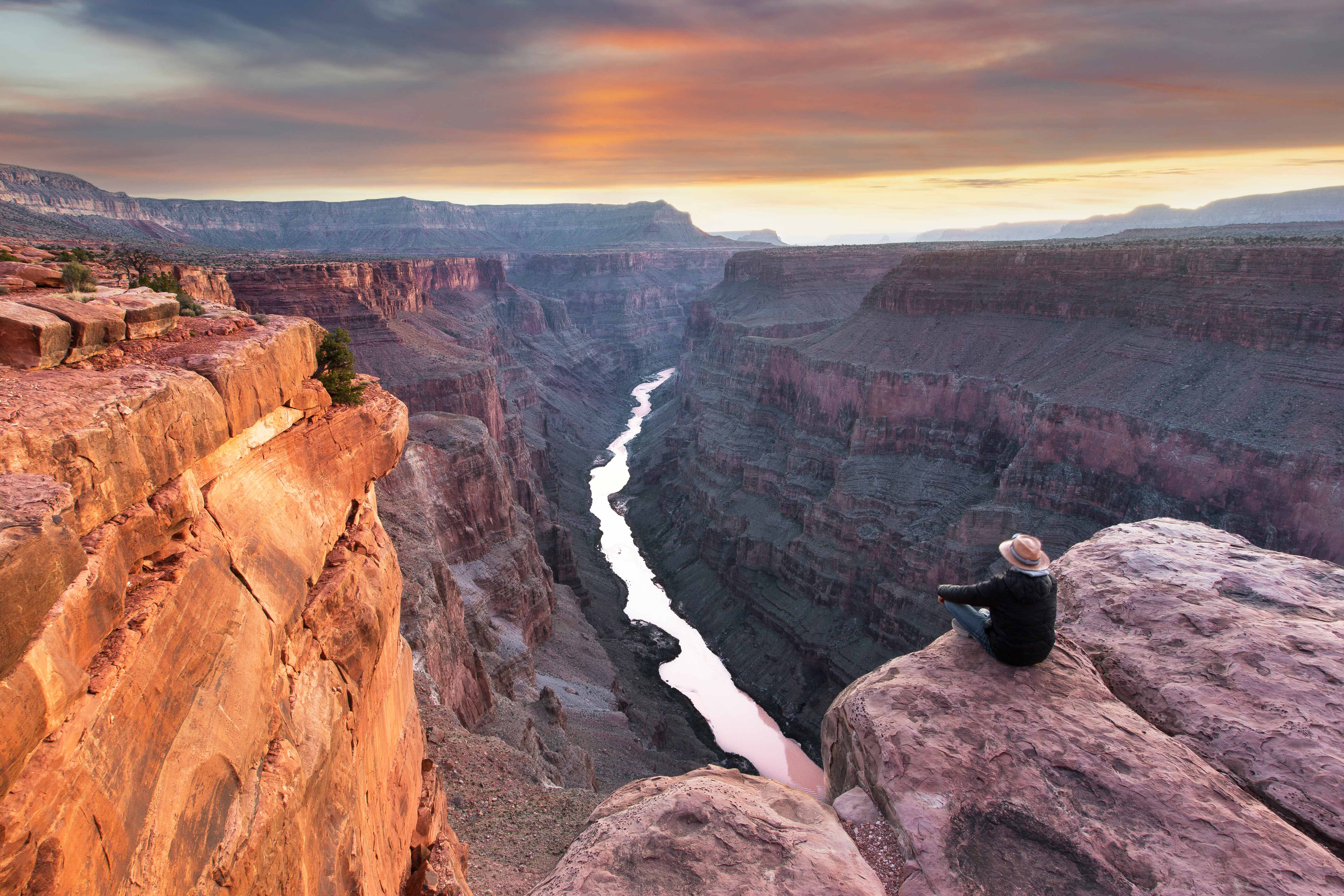 A hiker takes in the view at Toroweap Point on the North Rim of the Grand Canyon. Image by www.fischerfotografie.nl / Getty