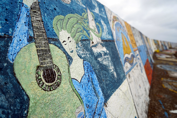 The crews of visiting yachts paint murals on the concrete of Horta's marina before they depart. Image by James Kay / Lonely Planet