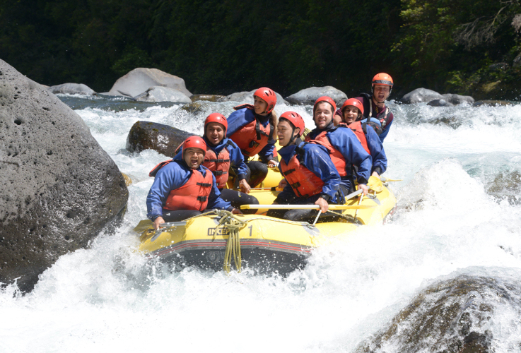 Raft full of adventure seekers navigating the Tongariro River. Image courtesy of Tongariro River Rafting.