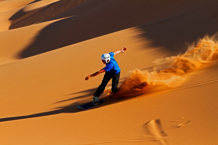 Sandboarding in the Namib, Namibia. Image by Klaus Brandstaetter / Getty Images