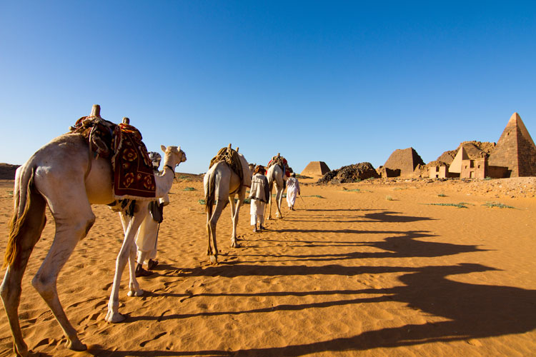 Camel men by the Begrawiya Pyramids, Meroe.Image by Stuart Butler / Lonely Planet.