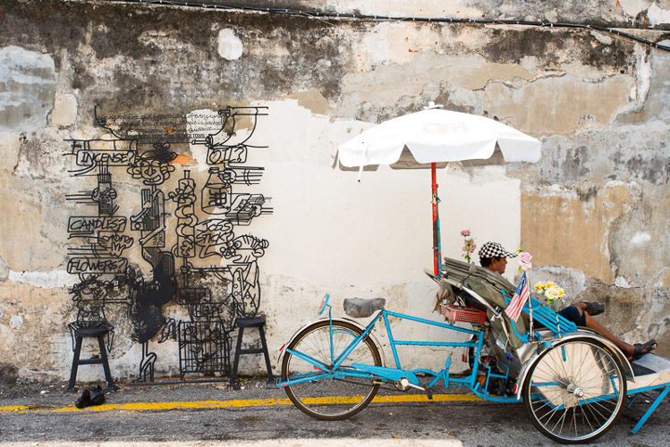 One of the 52 steel structures that grace walls and buildings of central George Town, Penang. Image by Lonely Planet
