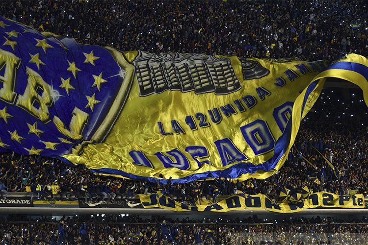 Fans unveil a giant flag at La Bombonera, Buenos Aires, to welcome Carlos Tevez