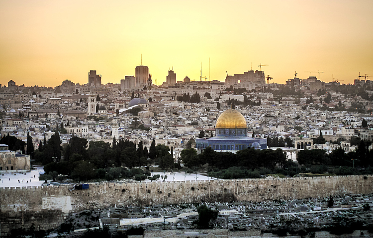 Sunset over Jerusalem, one of the world's holiest and most ancient cities. Image by Daniel Frauchiger / Getty Images 
