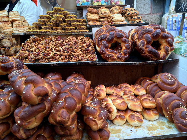 Mouthwatering breads and pastries are just two of the tempting food options on offer at Mahane Yehuda Market. Image by Virginia Maxwell / Lonely Planet