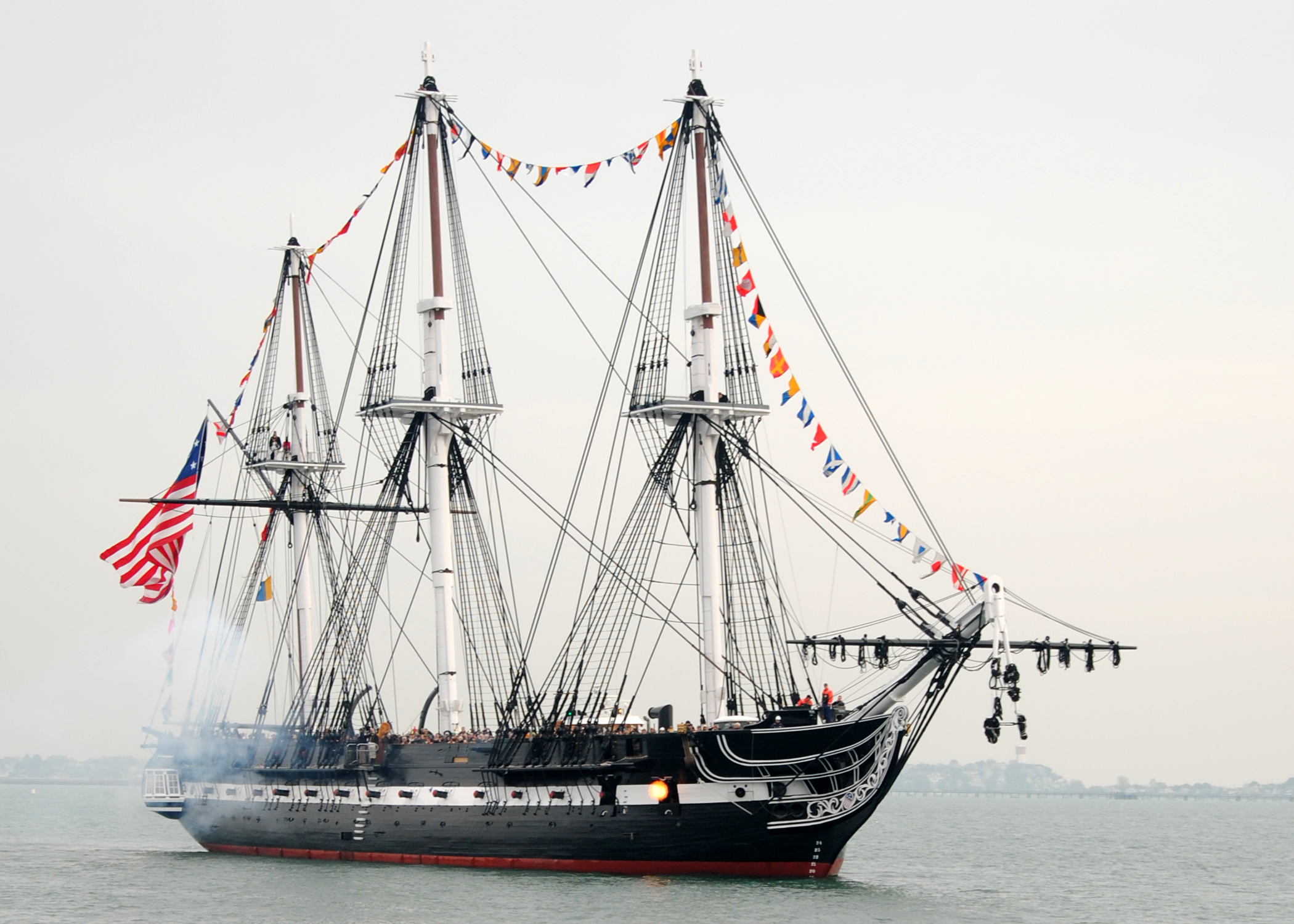 USS Constitution fires a 21-gun salute toward Fort Independence on Castle Island during an underway to celebrate Old Ironsides'  213th launching day anniversary. (U.S. Navy photo by: Petty Officer 3rd Class Kathryn E. Macdonald)