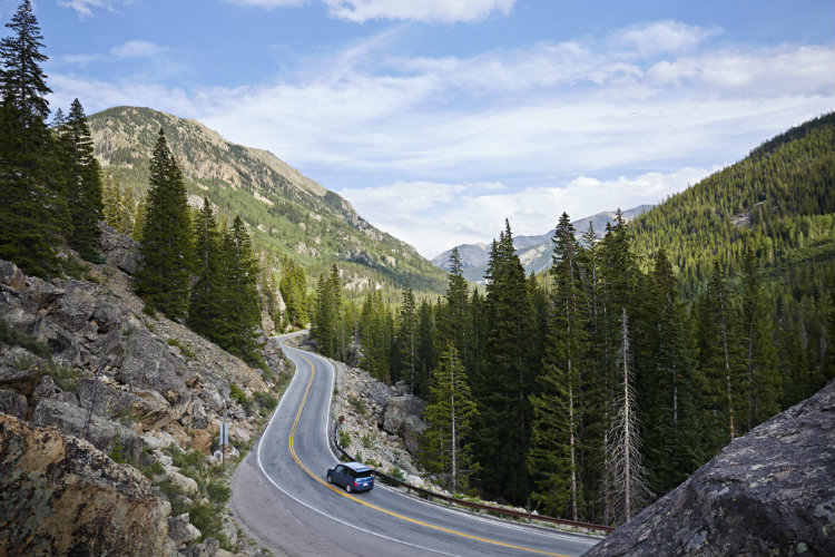 Car on winding highway, Aspen, Colorado, USA