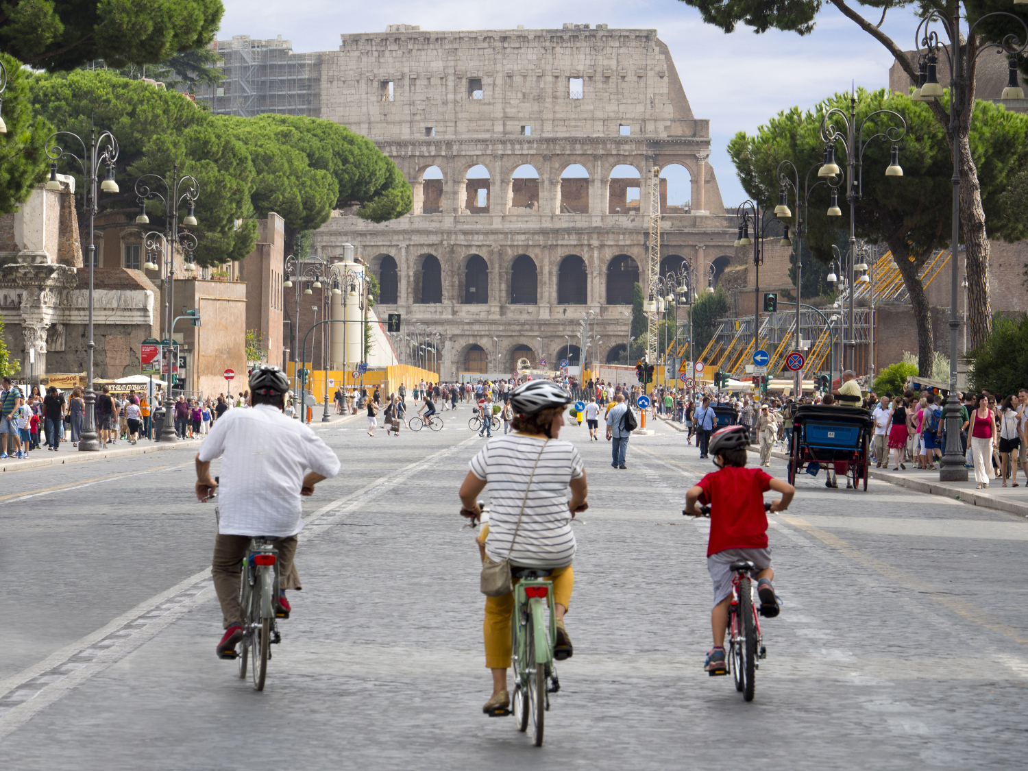 Cycling down Via del Fori Imperiali towards the Colosseum.