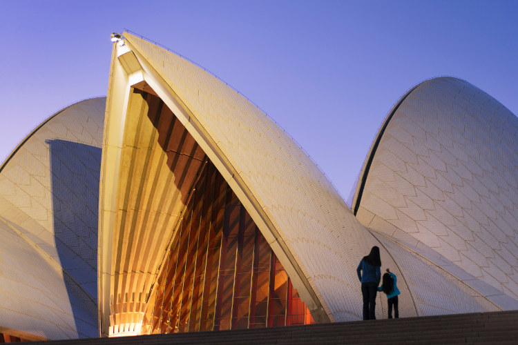 Admiring the Sydney Opera House at dusk. Image by Shaun Egan / Getty Images