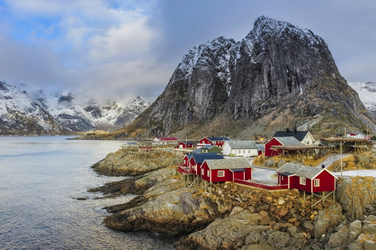 Traditional red houses in Hamnoy village, Lofoten Islands, Norway. Image by Dave Moorhouse / Moment / Getty