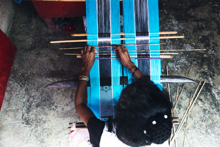 Weaver at work, Tais Market, Dili. Image by Brian Oh / Lonely Planet