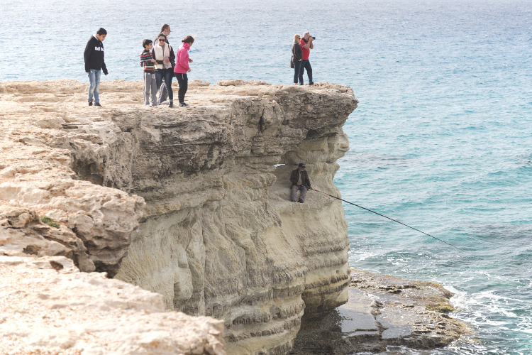 Fishing from a sea cave near Agia Napa. Image by Chris Mellor / Getty Images