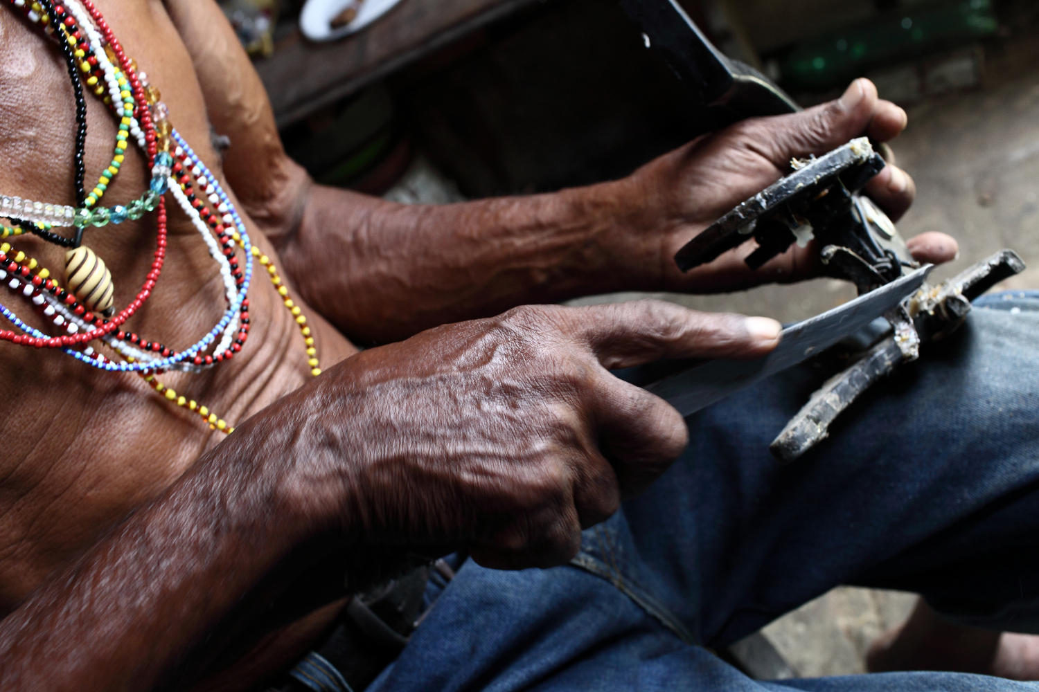 Cuban man carves a Santería orisha