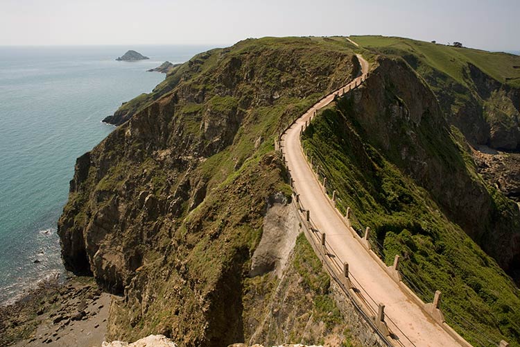 Sark's dramatic La Coupee, a narrow isthmus linking the island with Little Sark. Image by Rolf Richardson / Robert Harding World Imagery / Getty Images.