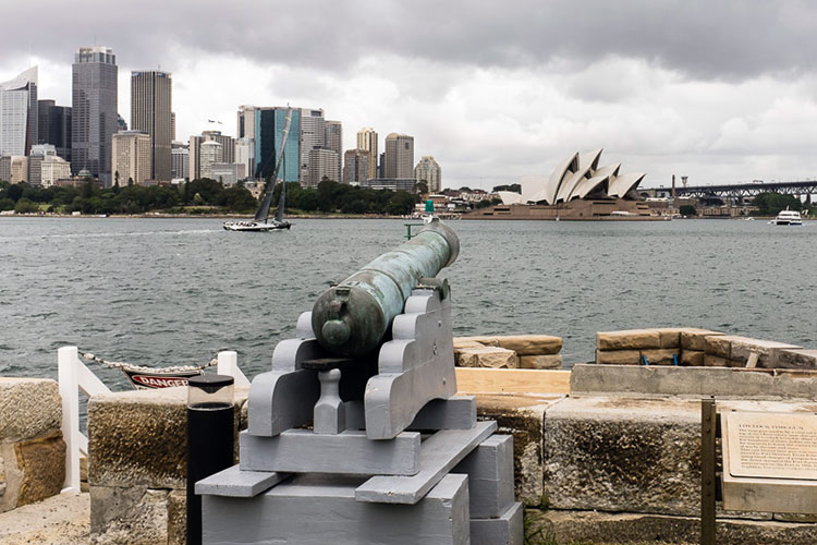 Cannon at Fort Denison pointing toward Sydney Opera House. Image by Glen Pearson / Lonely Planet.