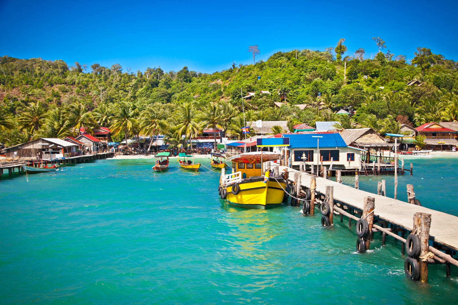 Boats docked on the turquoise waters of Koh Rong