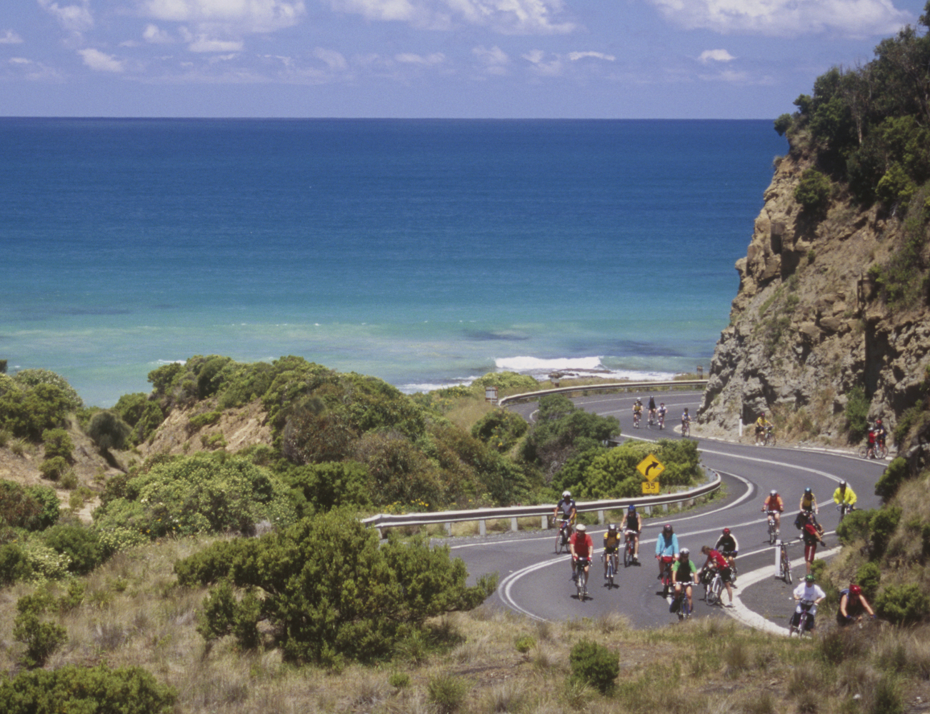 Cyclists tackling Australia's famous Great Ocean Road. © kgrahamjourneys / Getty Images 