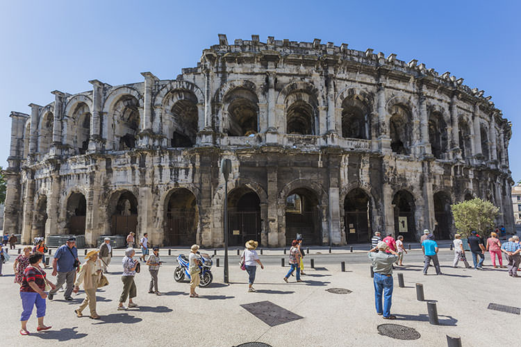 Tourists outside the 1st-century Arènes de Nîmes. Image by Ken Welsh / Photolibrary / Getty Images