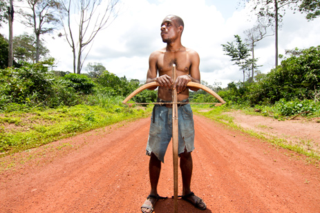A BaAka man holding a crossbow stands in the road near the village of Bayanga in southwest CAR. 