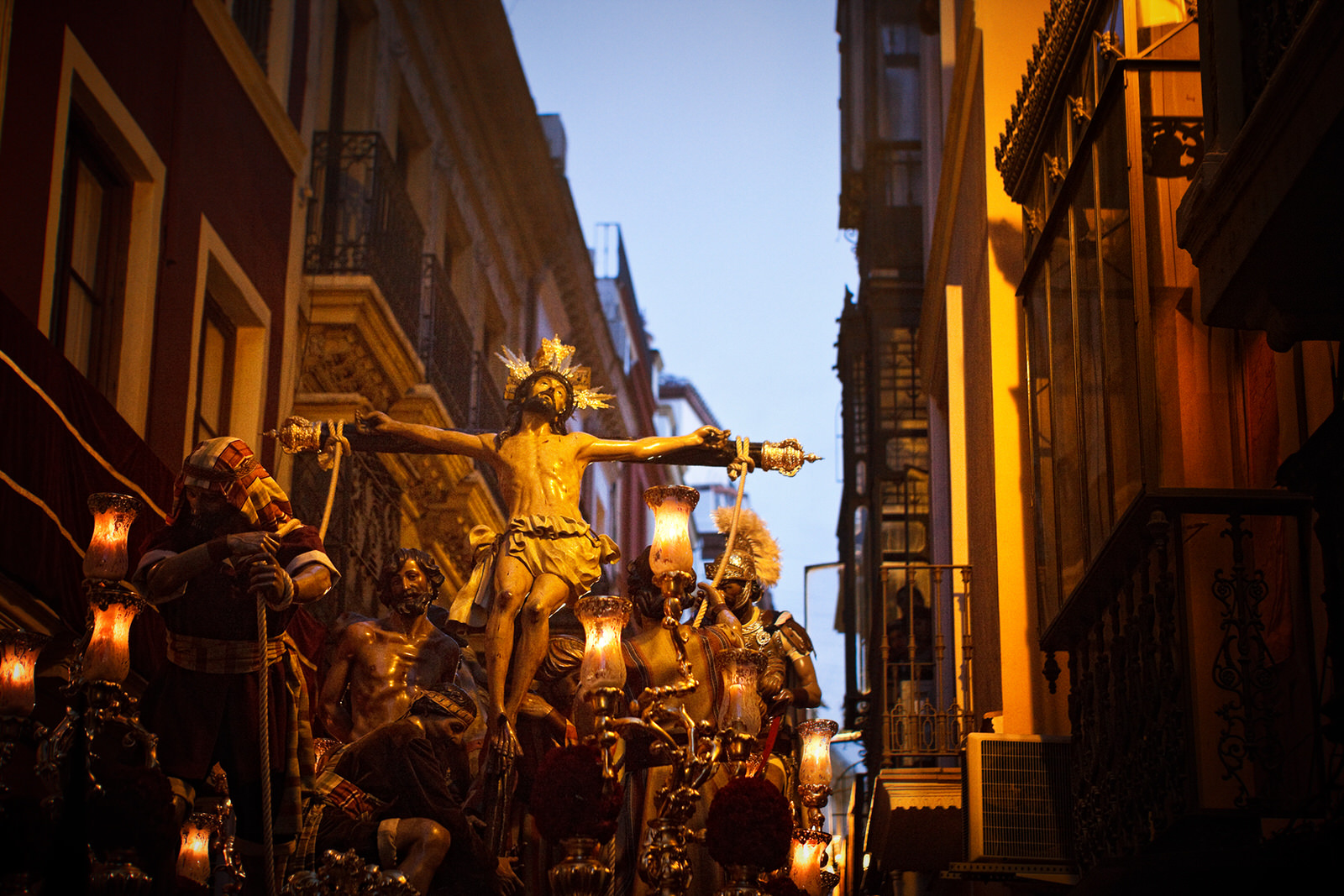 A float bearing a figure of Jesus Christ moves through the streets of Seville during Holy Week
