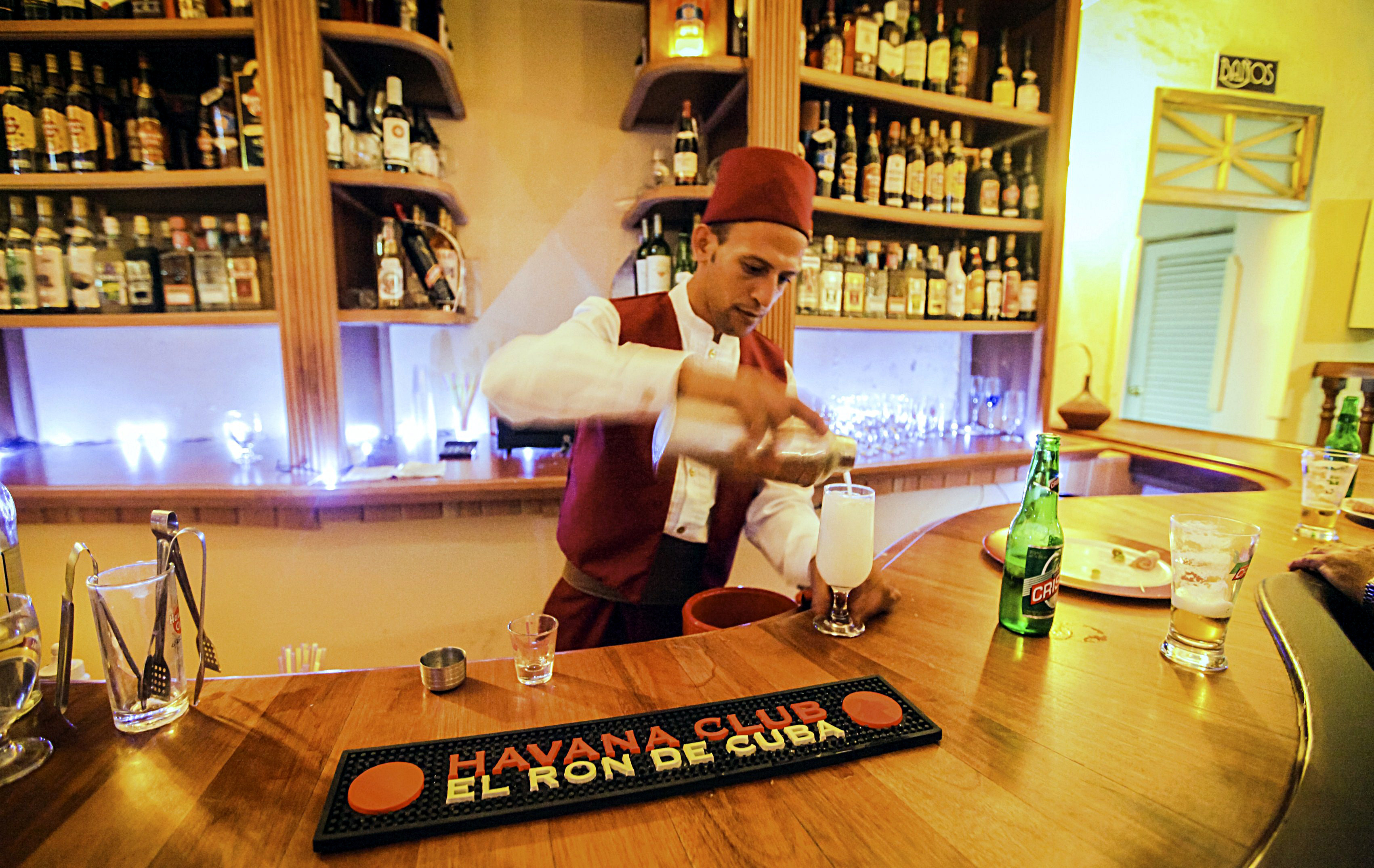 A bartender prepares a drink at the Casablanca bar in Camaguey. Image by Adalberto Roque / AFP / Getty