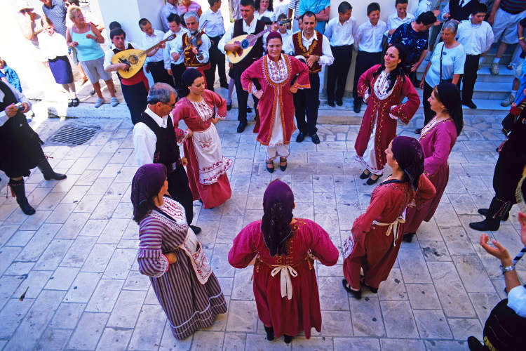 Festival dancing with Bouzouki instruments, St Mark's Square,Zakynthos. Image by Adina Tovy / Lonely Planet Images / Getty Images