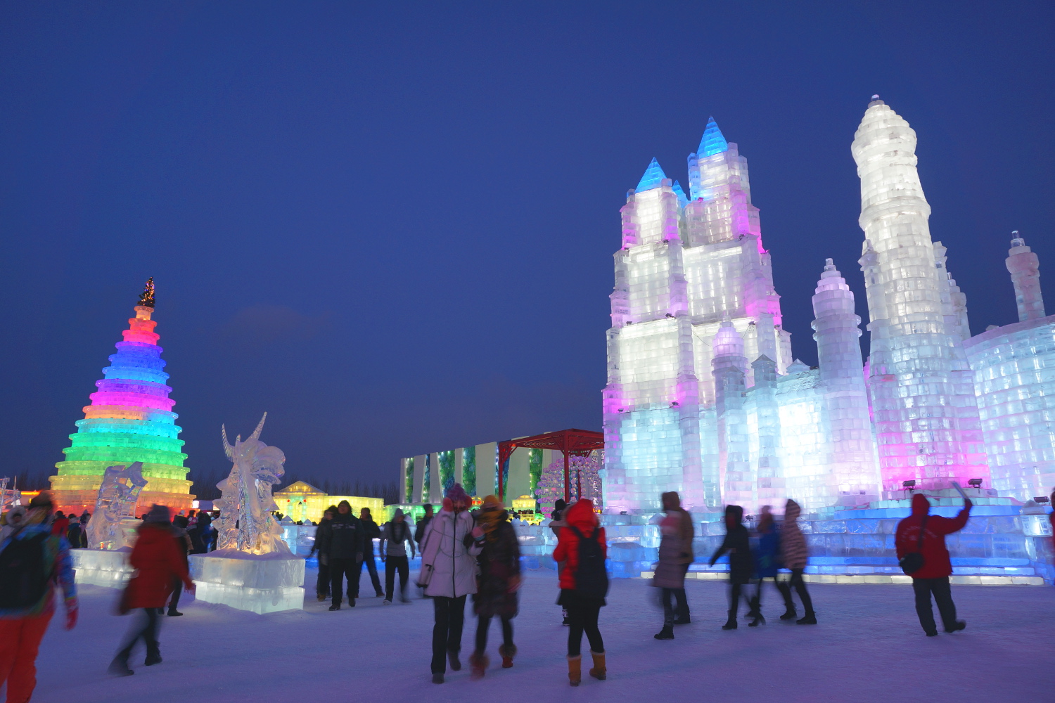 Colourful ice towers oversee Harbin's Ice and Snow World. Image by Anita Isalska / Lonely Planet