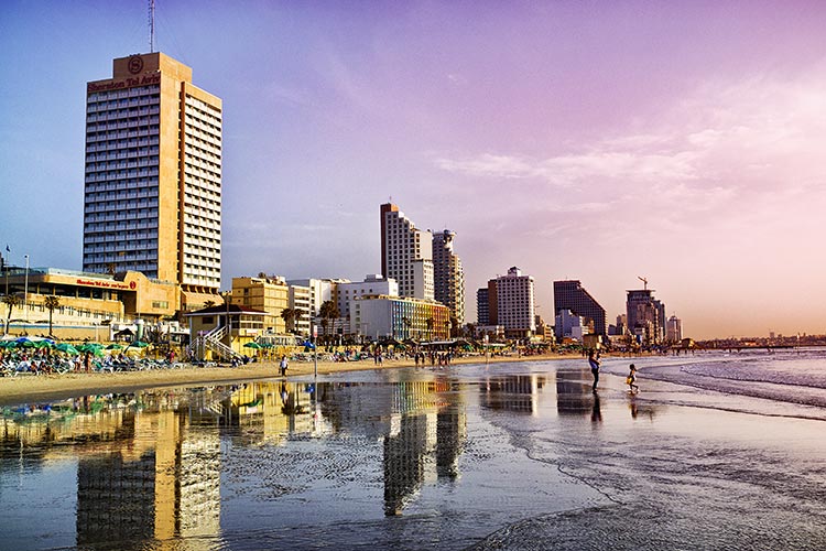 The beachfront of Tev Aviv is a popular spot in May. Image by Audun Bakke Andersen / Flickr / Getty Images.