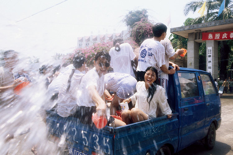 A group embracing the spirt of the Water Splashing Festival in Yunnan, China. Image by Diana Mayfield / Lonely Planet Images / Getty Images.