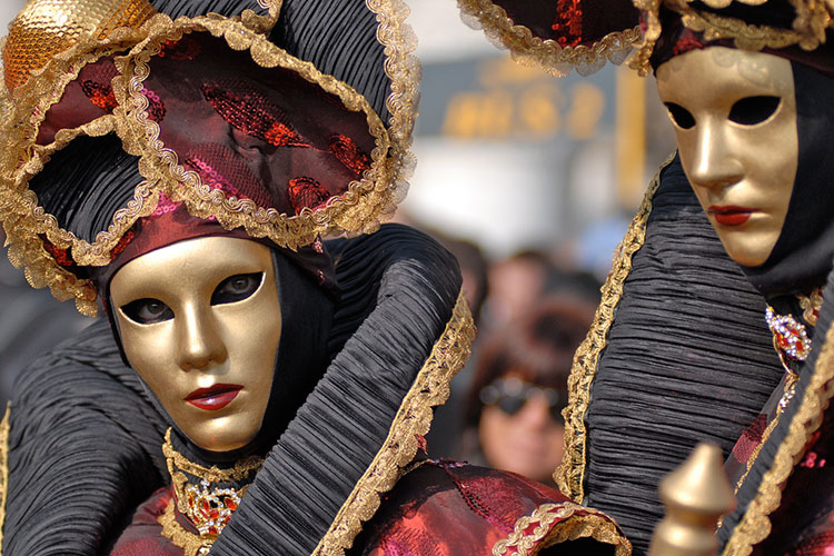 Masked revellers at Venice Carnival by Anja Johnson. CC BY 2.0.