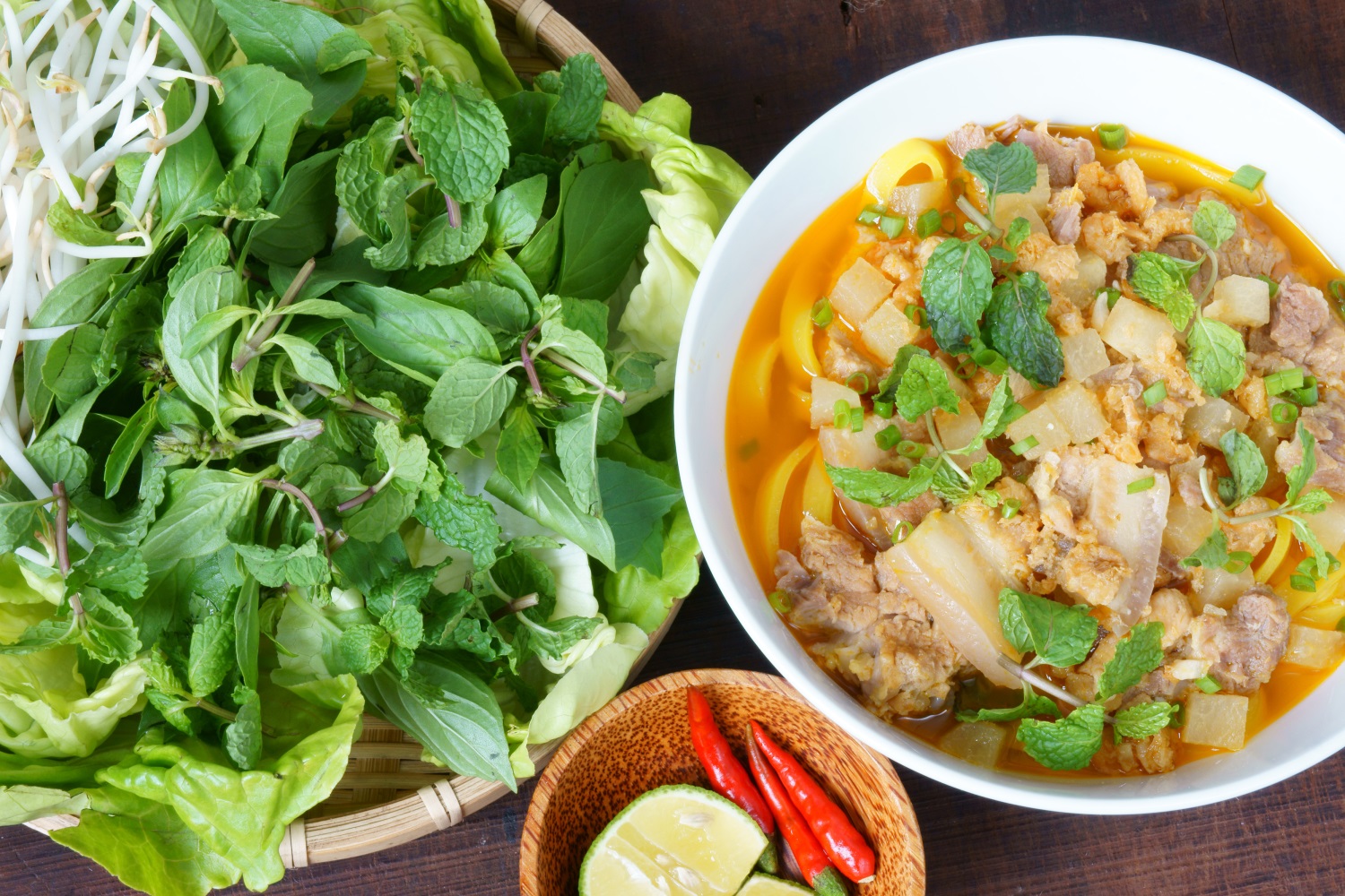 Bowl of mi quang with salad and other ingredients