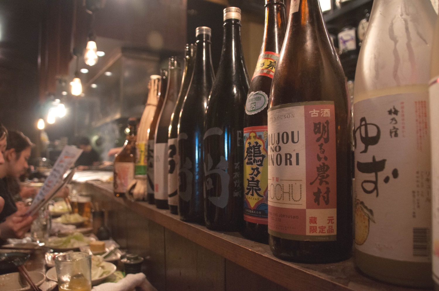 Sake and diners at Jōmon izakaya, Tokyo