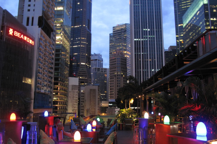 Iluminated tables with a cluster of Singapore skyscrapers in the background