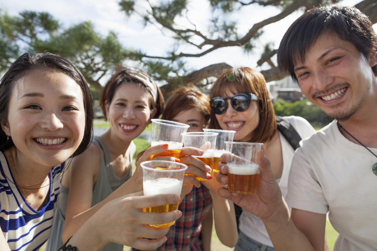 Beers in the sunshine bring out the smiles. Image by Mint / Getty Images