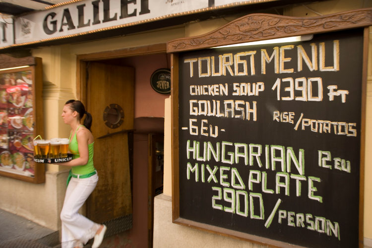 An open-air restaurant in Vaci Street, Budapest. Image by Ingolf Pompe / LOOK-foto / Getty Images