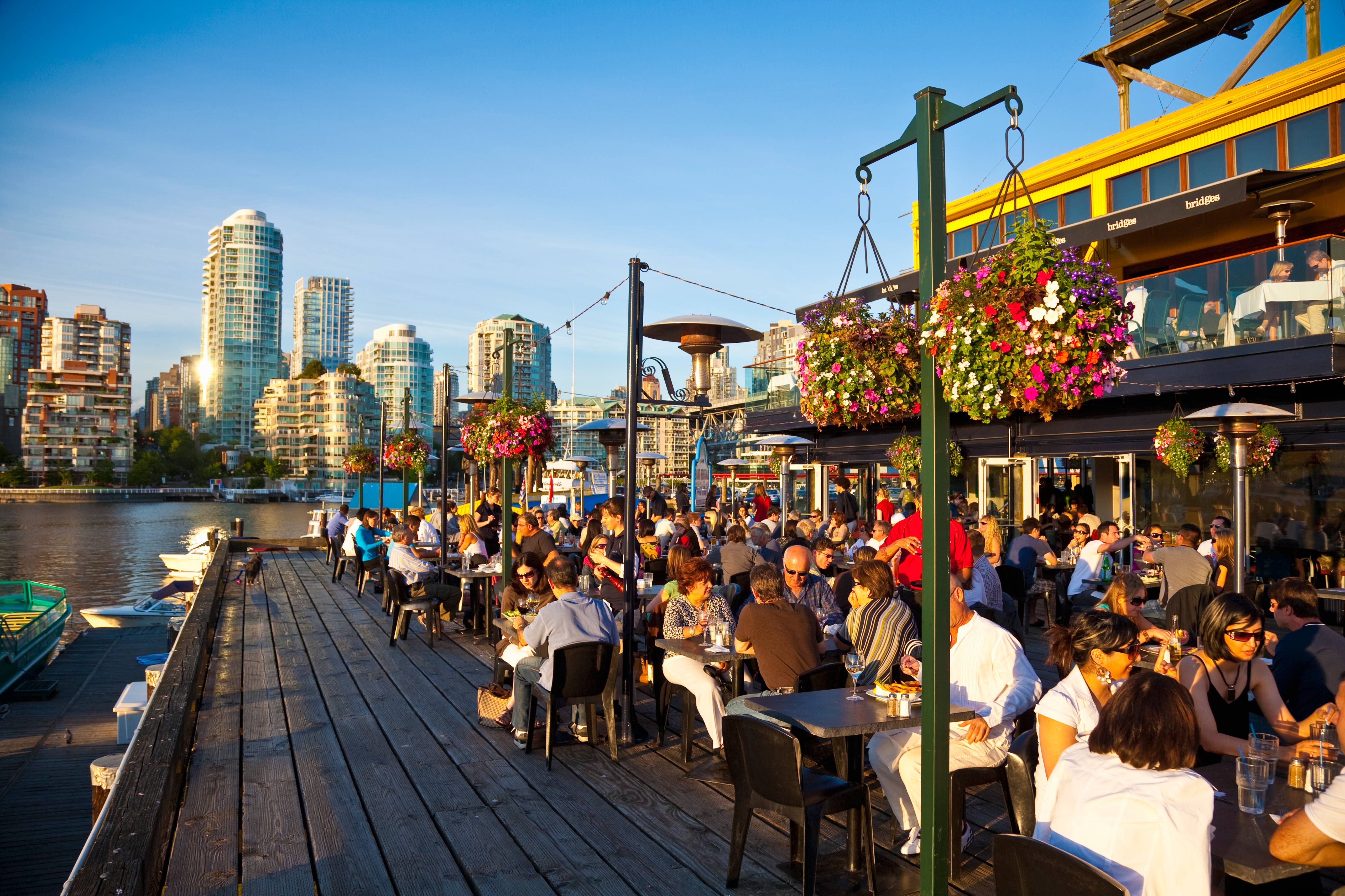 Alfresco dining on Granville Island, with Vancouver in the background. Image by Stuart Dee / The Image Bank / Getty