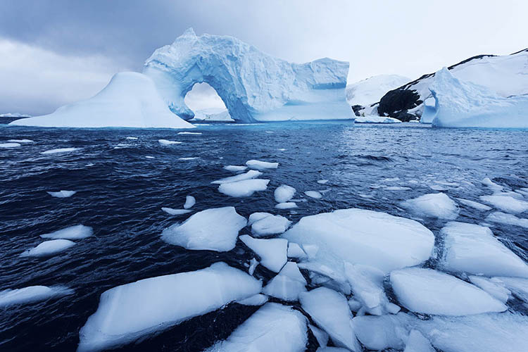 Nothing says 'forever' quite like ancient icebergs and the dark swirl of a glacial sea. Image by Henryk Sadura / Tetra Images / Getty Images