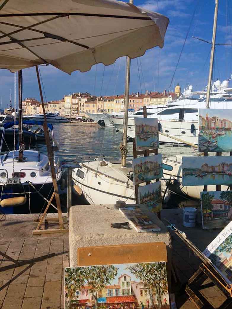Local artists line the port of St-Tropez every day, a tribute to the artistic pedigree of this Riviera village. Image by Kimberley Lovato / Lonely Planet.