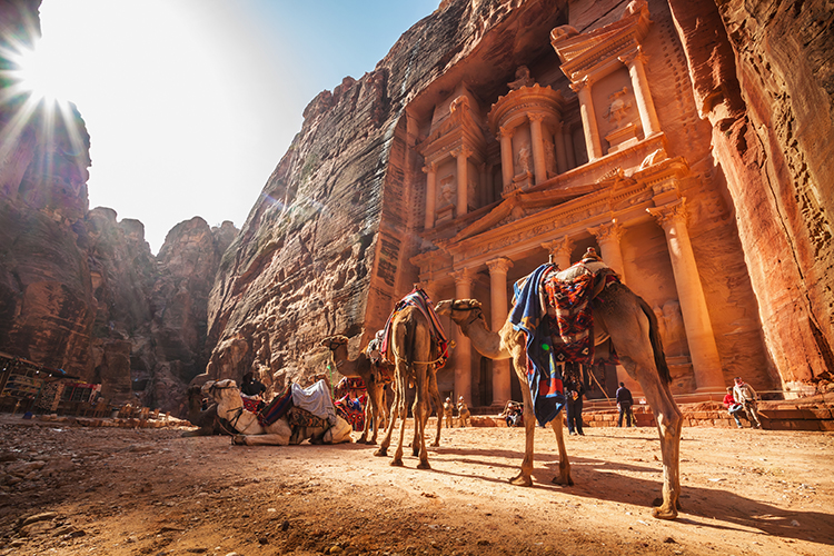 The facade of Petra's treasury is carved out of a sandstone rock face. Image by Reynold Mainse / Design Pics Perspectives / Getty Images