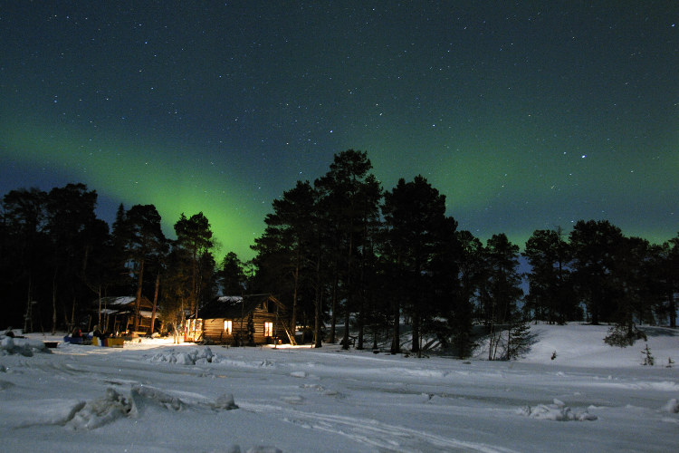 Northern lights over Karelia on the White Sea. Image by Wolfgang Poelzer / Getty Images