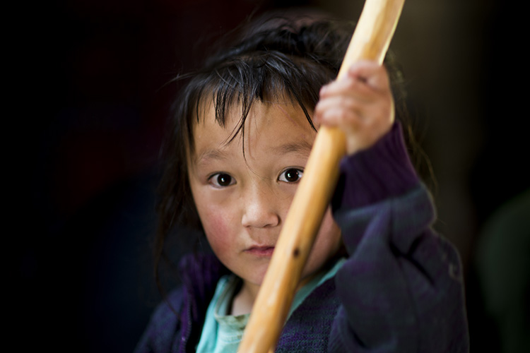 A child helps with chores. Image by Lonely Planet / David Baxendale