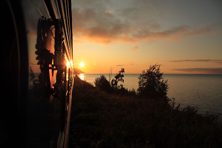 Lake Baikal at sunset seen from the railway line. Image by Image Source / Getty Images.