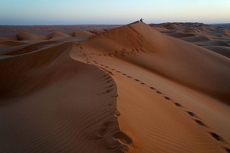 Sunset from the top of a giant sand dune is a one-of-a-kind photo opportunity. Image by James Kay / Lonely Planet
