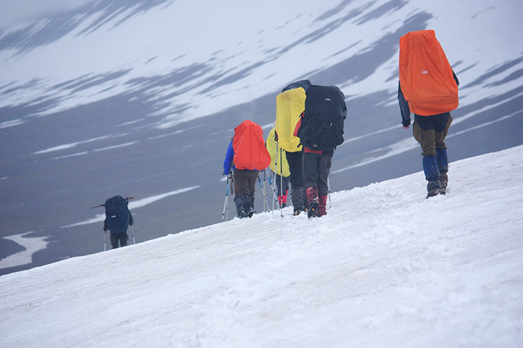 Packing light pays big when it comes to outdoor adventures, like this trek on Svalbard. Image by Kitty Terwolbeck / CC BY 2.0